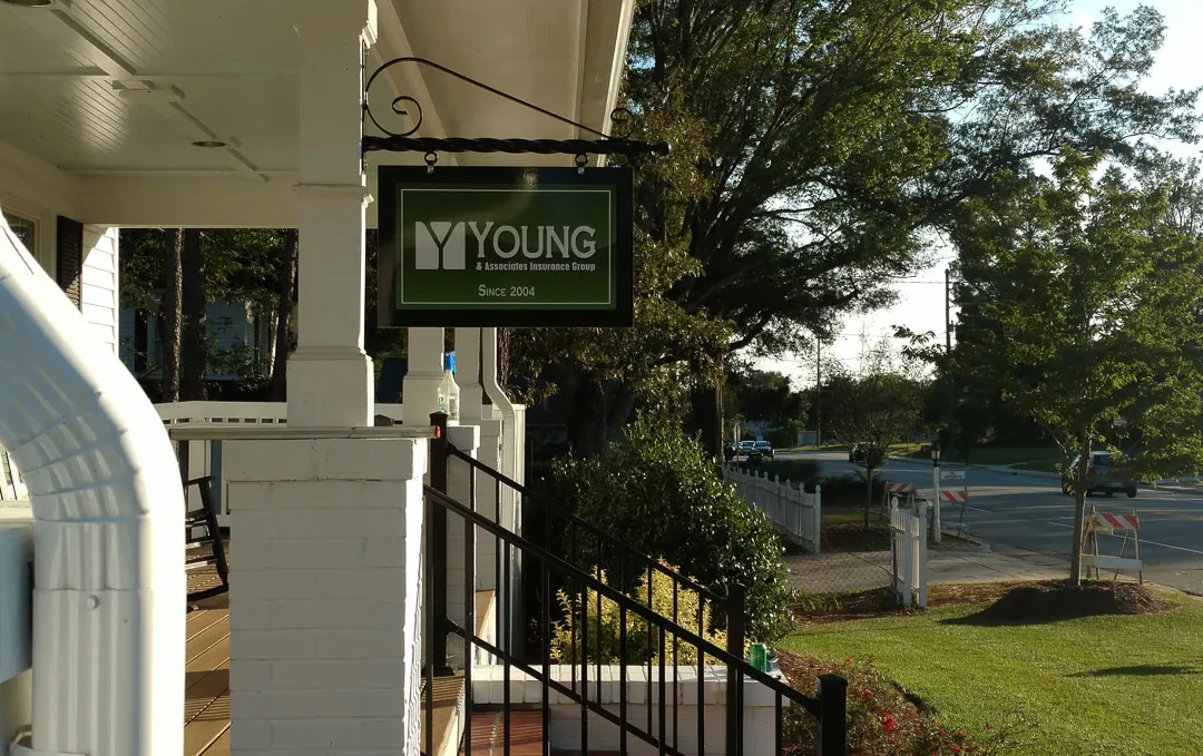 Hanging blade sign on porch for Young & Associates