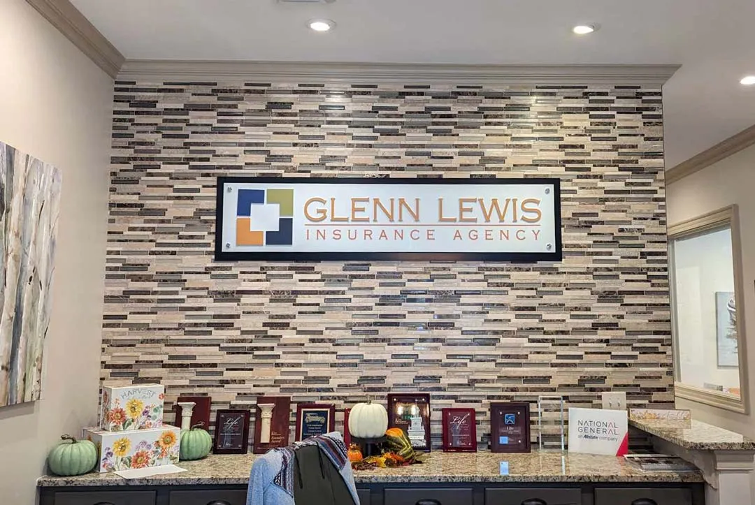 Lobby wall sign on stone for Glenn Lewis Insurance
