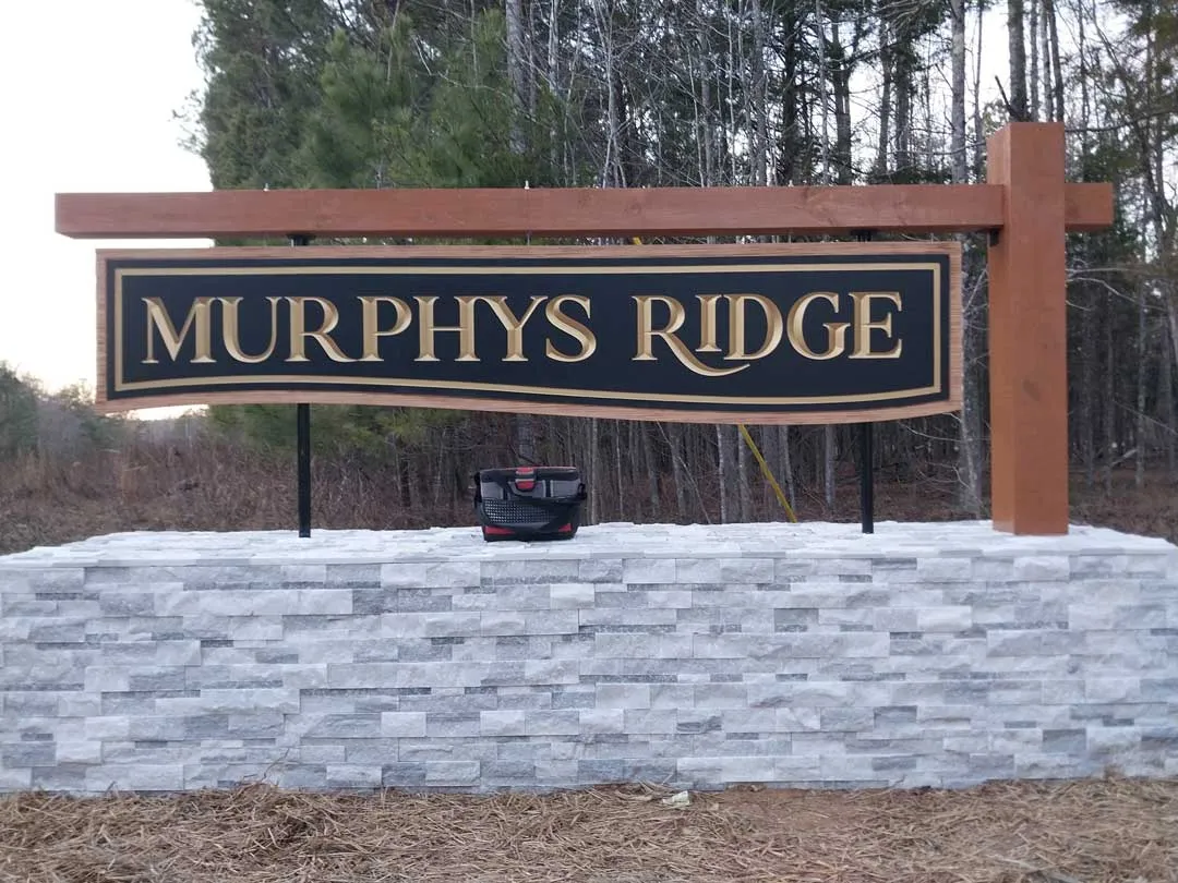 Hanging sign on timber over stone for Murphy's Ridge