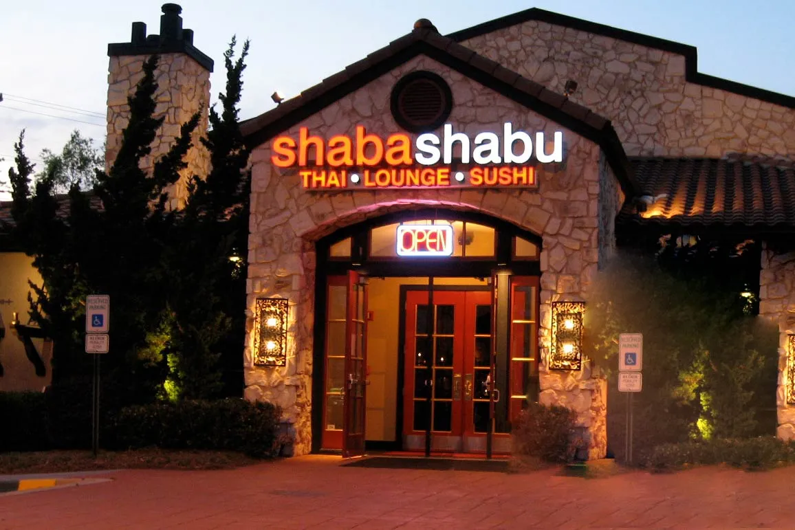 Lit letters on restaurant facade at dusk for Shaba Shabu